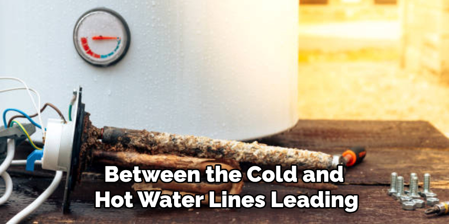 Between the Cold and
Hot Water Lines Leading